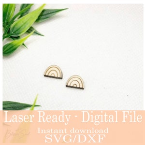 May include: Two small, wooden rainbow-shaped earrings with a light wood grain finish and dark brown outlines. The earrings are displayed on a white surface with green leaves in the background. The text "Laser Ready - Digital File" is visible.