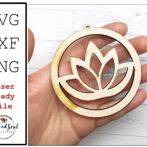 May include: A wooden laser-cut design of a lotus flower inside a circular frame. The image shows file types SVG, DXF, and PNG, with the text "Laser Ready File" and the Blessed Soul Creations logo.