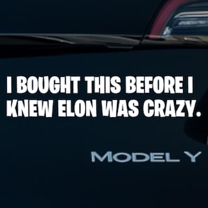 May include: A black Tesla Model Y with a white vinyl sticker that reads "I bought this before I knew Elon was crazy."