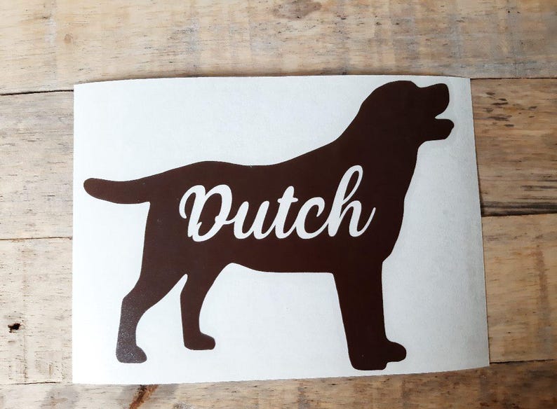 Op de afbeelding: Bruin silhouet van een hond met het woord "Dutch" in witte letters. De hond wordt staand afgebeeld. De sticker staat op een witte achtergrond.