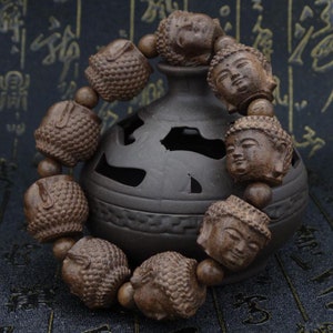 Ebony wood Buddha bead 1.5 cm by 2 cm, sold by 1 bead