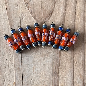 Indian blown glass bead mounted on a bronze metal rod, sold in pairs