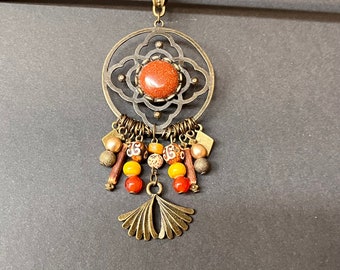 Ethnic pendant with a pyrite cabochon