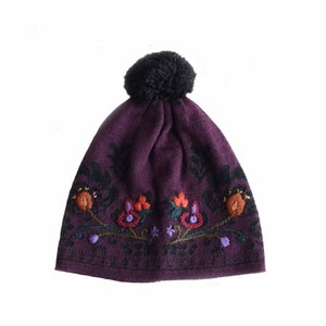 Beanie with pom pom, fine knitted hat with jacquard pattern purple shade -black.  hand embroidered flower detail on the front side.