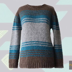 Women&#39;s alpaca wool sweater with soft brushed texture, three-color striped design, crew neck, hand-knitted in Peru, cozy winter pullover.