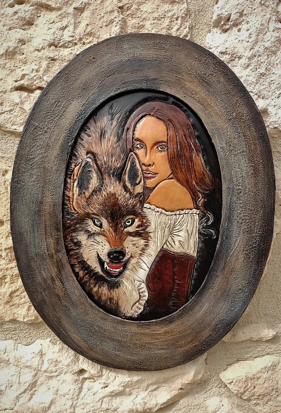 She-wolves, oval portrait on carved leather