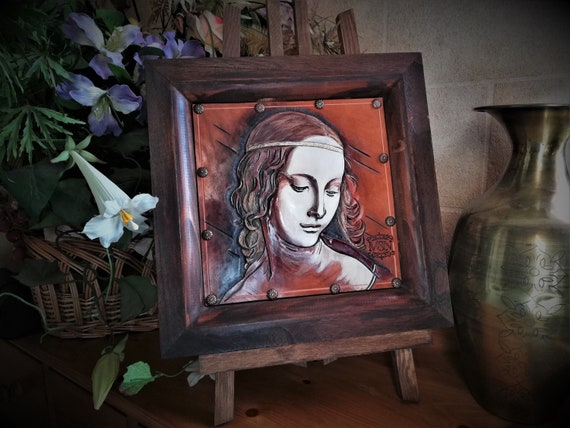 Portrait on carved leather in medieval style, of a Renaissance lass, maid, after a Da Vinci's drawing