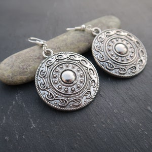 Large round silver hoop earrings with an ethnic feel