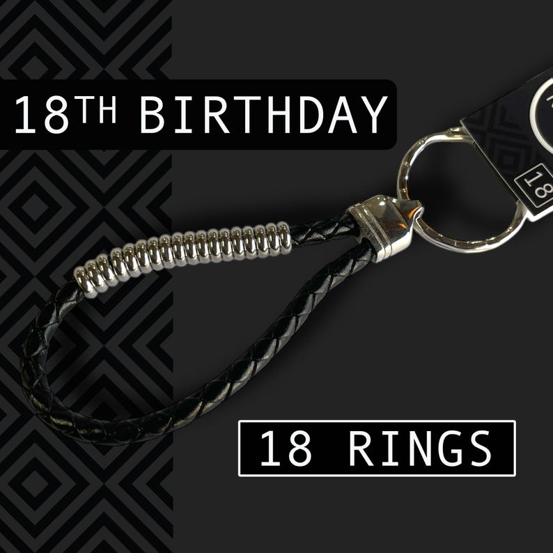 May include: Black leather keychain with silver accents. The keychain has a braided design and a metal ring. Text on the image reads "18th Birthday" and "18 Rings".