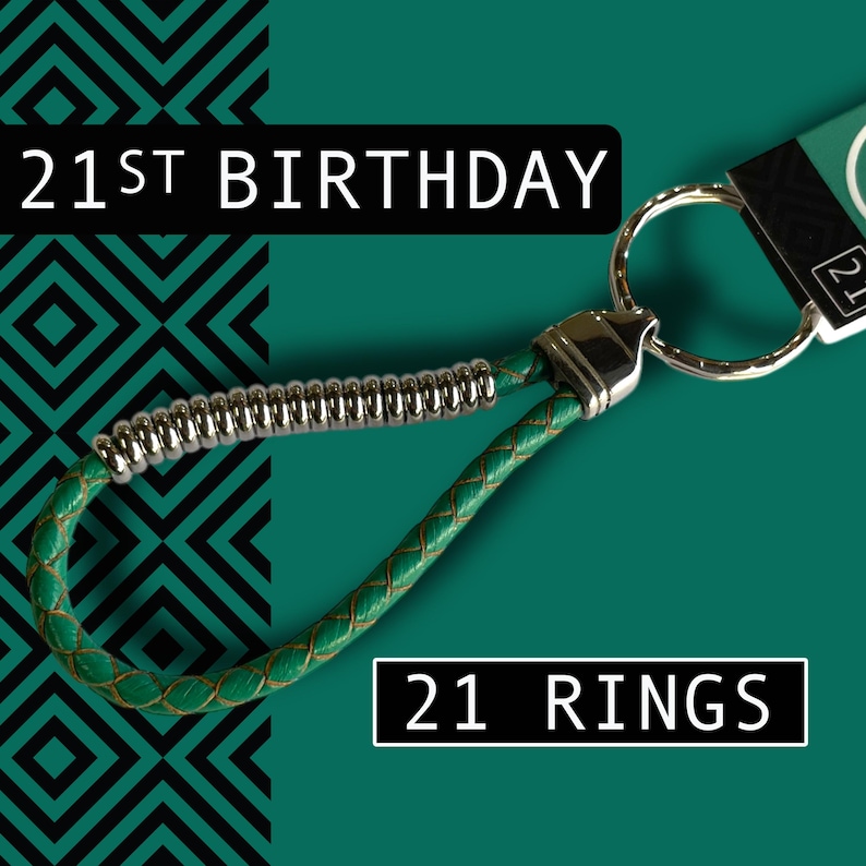 May include: Green leather keychain with a silver metal accent and a large metal ring. The text "21ST BIRTHDAY" and "21 RINGS" are displayed on the image. The background is teal with a black geometric pattern.