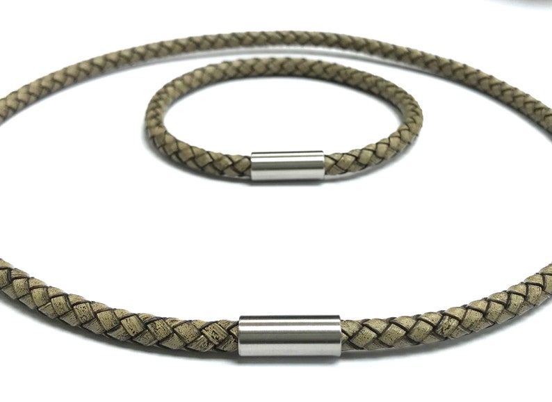 May include: Two braided leather necklaces with silver magnetic clasps. The necklaces are different lengths, one is longer than the other.