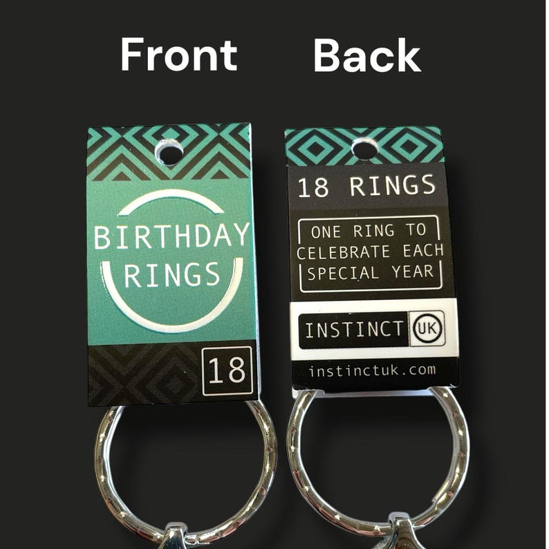 May include: Two keychains with tags. The front tag reads "BIRTHDAY RINGS" and "18". The back tag says "18 RINGS" and "ONE RING TO CELEBRATE EACH SPECIAL YEAR". The brand name "INSTINCT UK" is also visible.