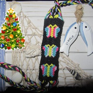 Brazilian bracelet with multi-colored butterflies on a black background