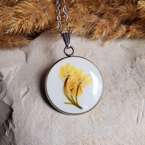 2.5 cm round pendant of dried lily of the valley flowers. Sold individually or with a chain. Dried flower necklace.