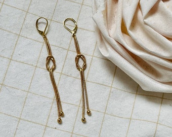 Long chain gold earrings, fine dangling gold earrings, knot motif jewelry