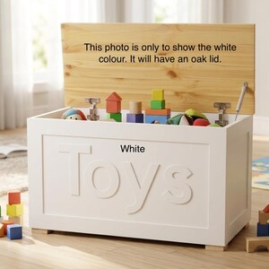 May include: A white rectangular toy chest with the word Toys embossed on the front. The chest features an open oak lid with the text: This photo is only to show the white colour. It will have an oak lid. The interior contains various colorful blocks.