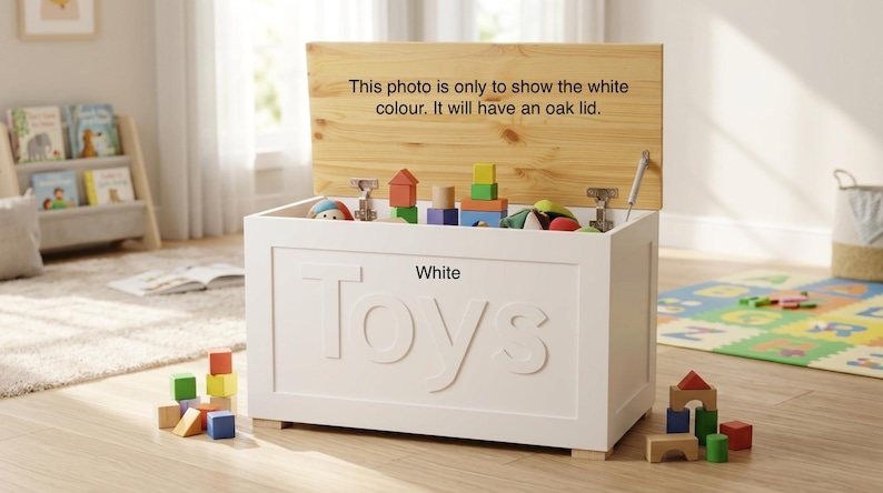 May include: A white rectangular toy chest with the word Toys embossed on the front. The chest features an open oak lid with the text: This photo is only to show the white colour. It will have an oak lid. The interior contains various colorful blocks.
