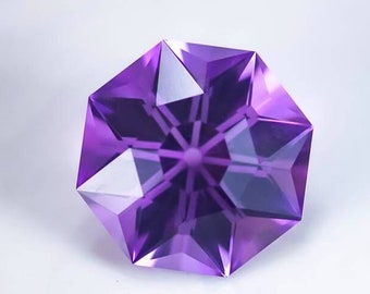 May include: A purple amethyst gemstone with a star-shaped cut. The gemstone is faceted and has a high polish.