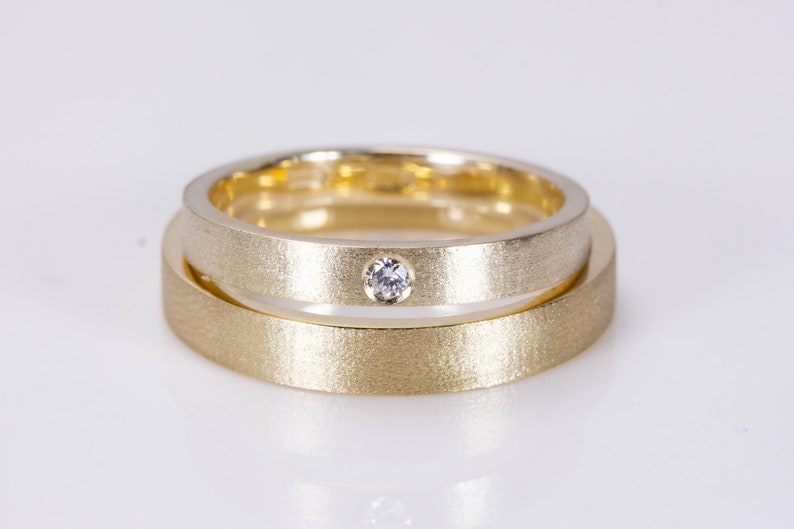 Gold wedding rings set with diamond in Hers ring. Matte image 1