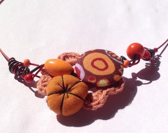 Springtime choker with hand crocheted flower, fabric covered button and jewelry wire .