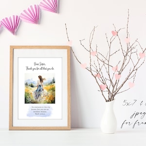 May include: A framed print with a watercolor painting of a woman walking in a field. The text reads "Dear Sister, Thank you for all that you do." and "for everyone in the city knows that you are an excellent woman. Ruth 3:10,11". The print is on a white surface with a vase of pink hearts on branches.
