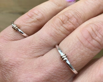 Spinning slim silver ring with gold hoops