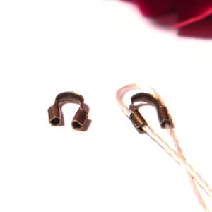 May include: Two bronze crimp end caps for jewelry making. The caps are open and ready to be crimped onto cord or string.
