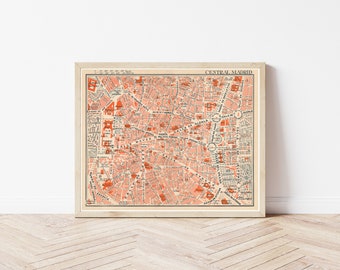 May include: Vintage map of Central Madrid, Spain, printed in black and white with red highlights. The map shows the city's streets and landmarks, including the Plaza Mayor, Calle de Alcalá, and the Puerta del Sol.