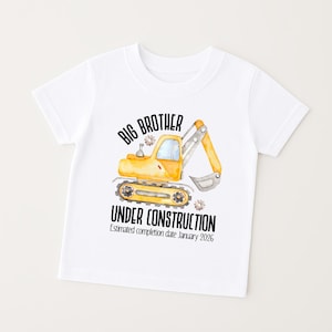 a white short sleeved big brother t-shirt featuring a sweet watercolour digger design with the words'BIG BROTHER' arched over the top and 'UNDER CONSTRUCTION 'below and personalised with baby's due month and year