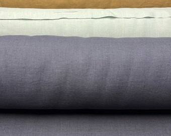 May include: Five rolls of fabric in different colors, including light gray, mustard yellow, light green, dark blue, and a darker shade of blue. The fabric is a linen blend and has a textured surface.