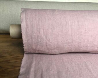 May include: A roll of soft, pink linen fabric. The fabric has a natural, slightly textured surface.