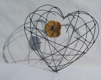 Annealed iron wire heart, placed or suspended with a yellow flower Raku