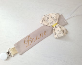 Clip per ciuccio personalizzata beige e oro, fiocco floreale