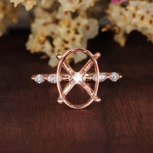 May include: A rose gold ring setting with a pave diamond band and an oval shaped center stone setting.