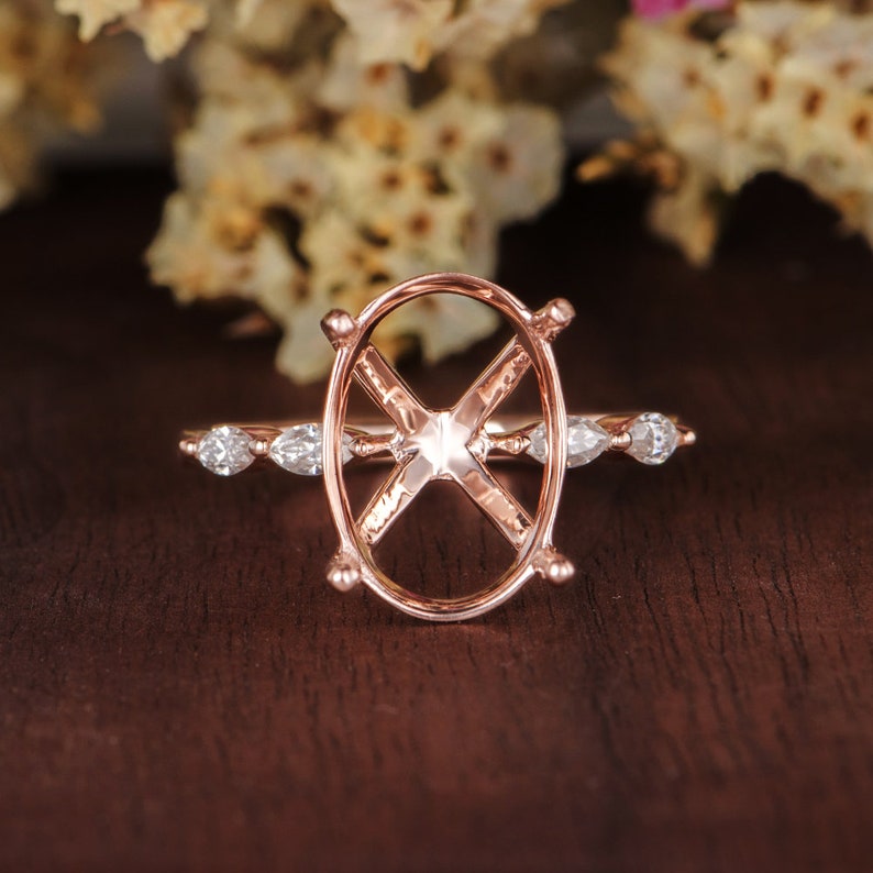 May include: A rose gold ring setting with a pave diamond band and an oval shaped center stone setting.
