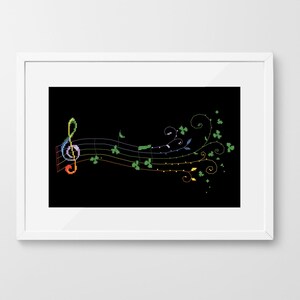 May include: A black and white image of a treble clef and musical notes with a rainbow design. The notes are surrounded by green shamrock leaves.