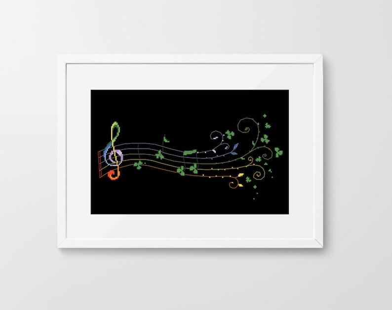 May include: A black and white image of a treble clef and musical notes with a rainbow design. The notes are surrounded by green shamrock leaves.