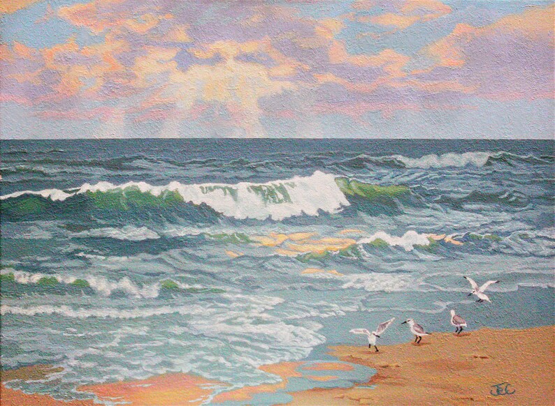 Print of my original beach sunrise painting on canvas.Golden sunlight streaming through the clouds reflect on the ocean waves & the shoreline where seagulls have gathered.Blue sky with pink, purple & golden yellow sunrise clouds.Peaceful seascape.