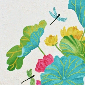 My painting of blue, green, and yellow lotus flowers with dragonfly accents on a white background.
