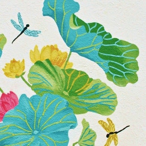 My painting of blue and green lotus leaves with yellow flowers and two dragonflies, one blue and one yellow, on a white background.