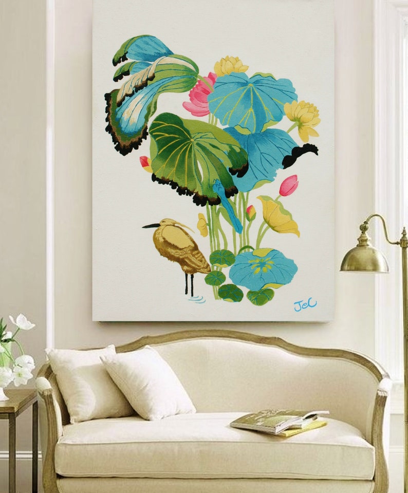 Print of my original water lilies painting featuring a nature scene with a golden wading bird and vibrant lotus plants against a white background. A long-beaked, golden-brown bird stands in ripples of water at the bottom left. Large, oversized lily pads in shades of bright green, teal, and turquoise dominate the center, detailed with delicate blue veins and scalloped dark edges. Soft pink and pale yellow lotus blossoms bloom on tall, slender stems. Signed "JeC" in script at the bottom right.
