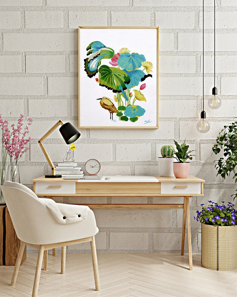 Print of my original water lilies painting featuring a nature scene with a golden wading bird and vibrant lotus plants against a white background. A long-beaked, golden-brown bird stands in ripples of water at the bottom left. Large, oversized lily pads in shades of bright green, teal, and turquoise dominate the center, detailed with delicate blue veins and scalloped dark edges. Soft pink and pale yellow lotus blossoms bloom on tall, slender stems. Signed "JeC" in script at the bottom right.
