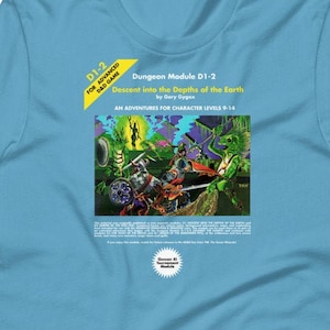 May include: A blue t-shirt with a Dungeons and Dragons module cover printed on the front. The cover features a fantasy illustration of characters fighting monsters in a forest setting. The text on the cover reads "Dungeon Module D1-2 Descent into the Depths of the Earth by Gary Gygax An Adventure for Character Levels 9-14".