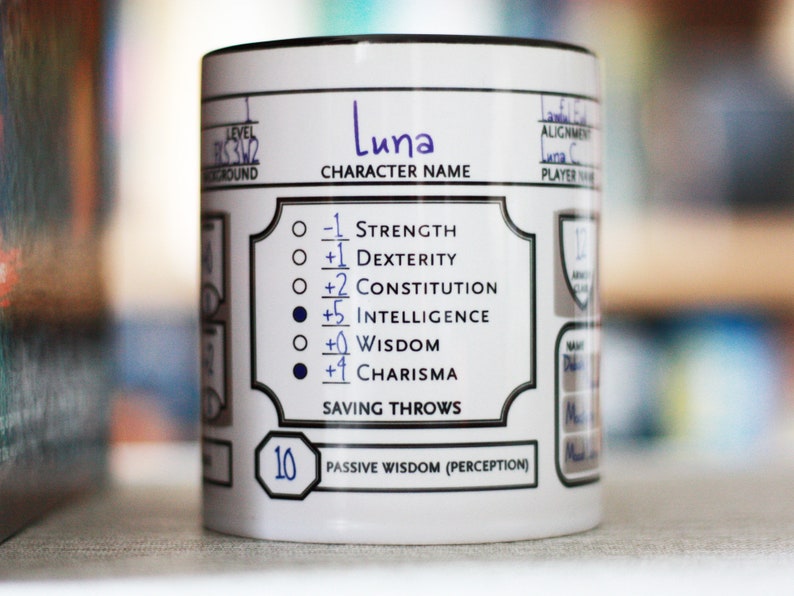 May include: White ceramic mug with a black rim and a black and white character sheet design. The character name is "Luna" and the character sheet includes stats for Strength, Dexterity, Constitution, Intelligence, Wisdom, and Charisma. The mug also includes a passive wisdom (perception) score of 10.