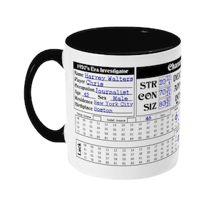 May include: A white ceramic mug with a black handle and rim. The mug features a black and white character sheet with the text "1920's Era Investigator" and "Harvey Walters". The character sheet includes stats like "STR", "CON", and "SIZ".