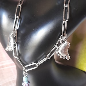 “Feet” anklet, stainless steel chain, silver metal feet, glass beads