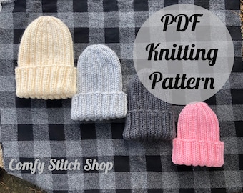 May include: Four ribbed knit beanies in cream, light gray, dark gray, and pink are displayed on a black and white checkered blanket. The image includes the text "PDF Knitting Pattern" and "Comfy Stitch Shop".