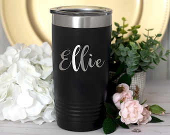 May include: Black stainless steel tumbler with a silver lid and the name "Ellie" engraved on the front.