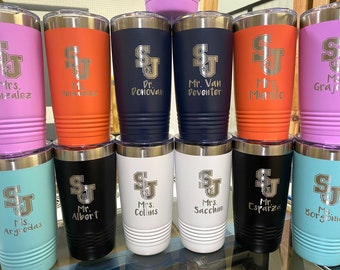 May include: Ten stainless steel tumblers with various colored exteriors and silver lids. Each tumbler has a silver logo with the letters "SJ" and a personalized name underneath. The names include "Mrs. Gonzalez", "Mrs. Hernandez", "Dr. Donovan", "Mr. Van Deventer", "Mrs. Murlo", "Ms. Grajed", "Ms. Arguedas", "Mr. Albert", "Mrs. Collins", "Mrs. Sacchini", "Mr. Esparza", and "Ms. Borgonia".