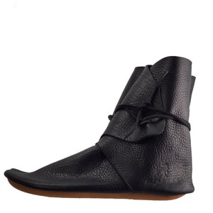 K&ouml;nnte beinhalten: Schwarze Lederstiefel mit Schn&uuml;rung und abgerundeter Spitze. Die Stiefel haben ein Obermaterial aus strukturiertem Leder und eine braune Sohle.